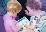 Babies playing on a tablet.